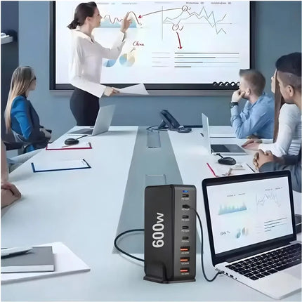 600W USB charging station powering a laptop tablet earbuds and phone on a desk