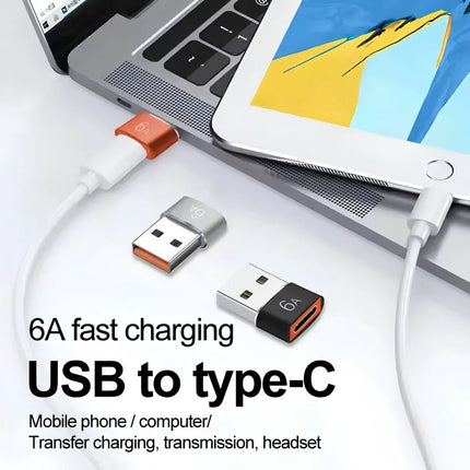 USB-A to USB-C female adapter connected to laptop for charging and data use